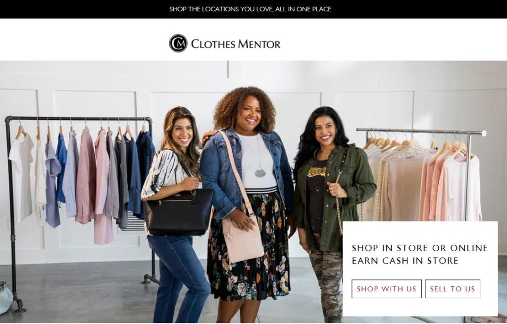 Three millennial women standing in a room with clothing hanging on racks behind them. They are modeling their fashion style.